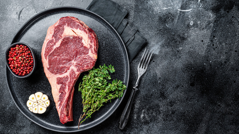 Raw cowboy steak.