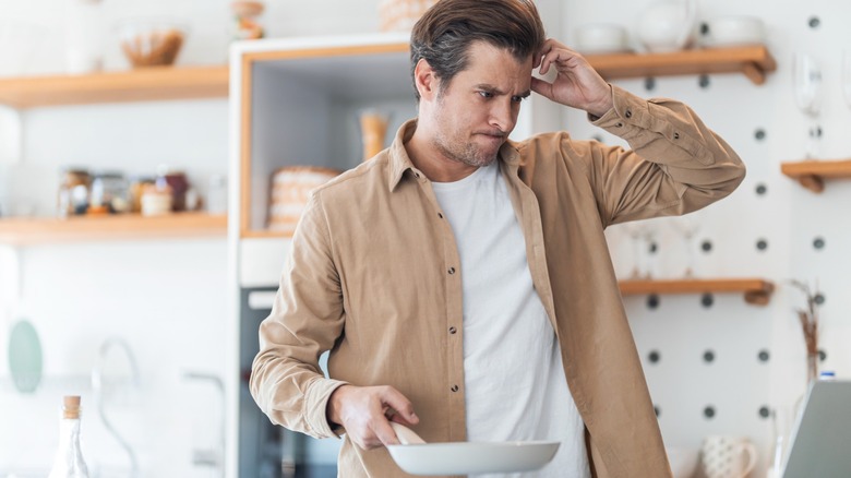 confused man in kitchen