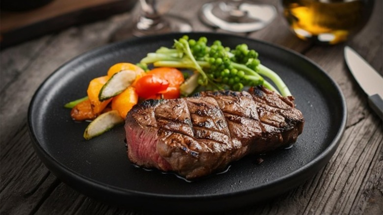 expertly cooked steak with veggies sides