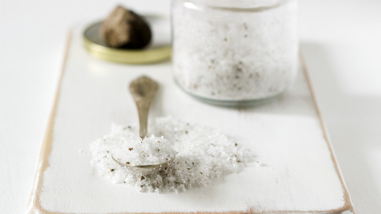 spoonful of truffle salt in front of jar