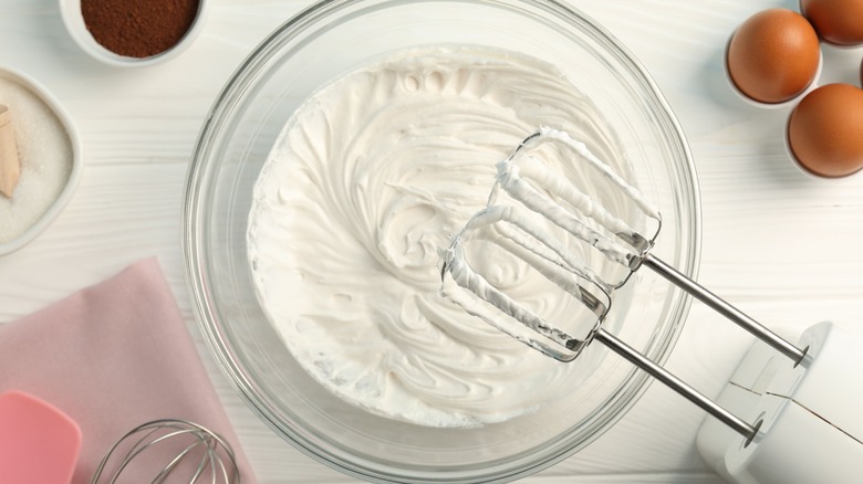 whipped cream in a bowl with mixer