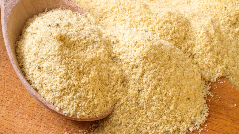 Chicken stock powder on a wooden spoon