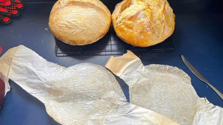 sourdough bread with two used parchment paper slings