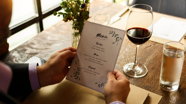 Someone looking at a restaurant menu