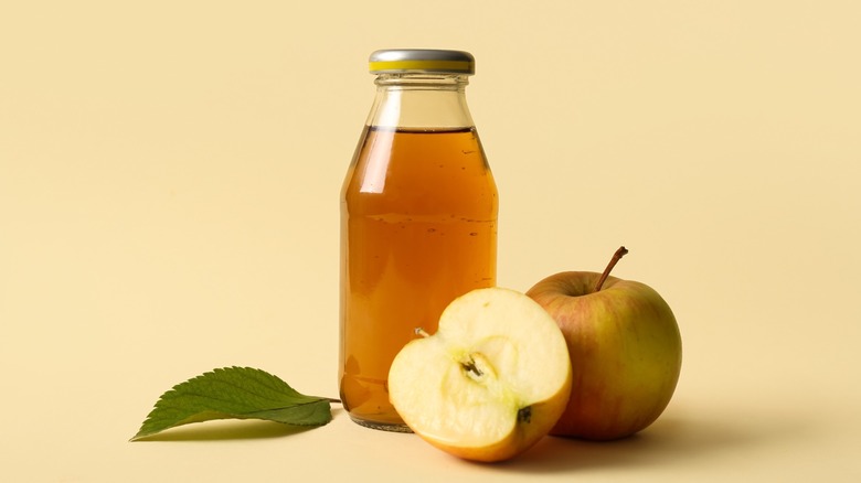 apple juice with fruit, yellow background