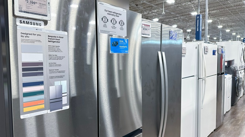 Lineup of refrigerators for sale at store, including Samsung models.