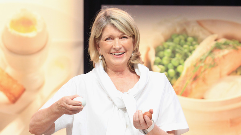 Martha Stewart smiling on stage during cooking demo.