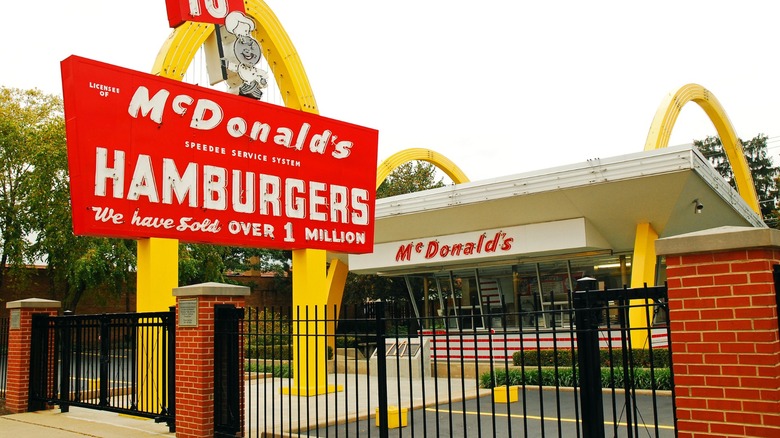 an old-school mcdonald's restaurant surrounded by a gate