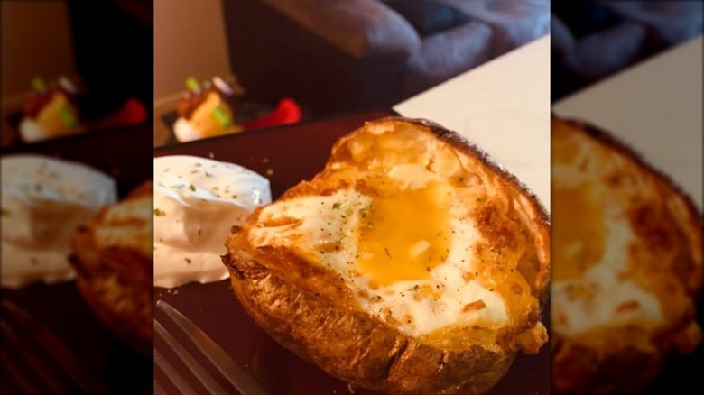 baked potato stuffed with egg and served with sour cream
