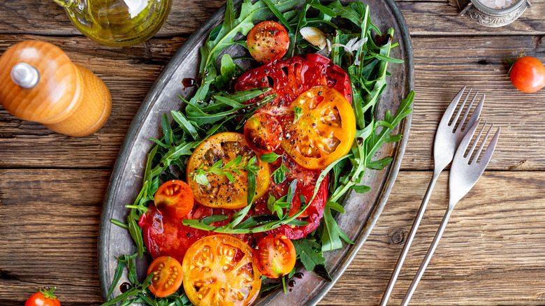 tomato salad in bowl with olives and onion