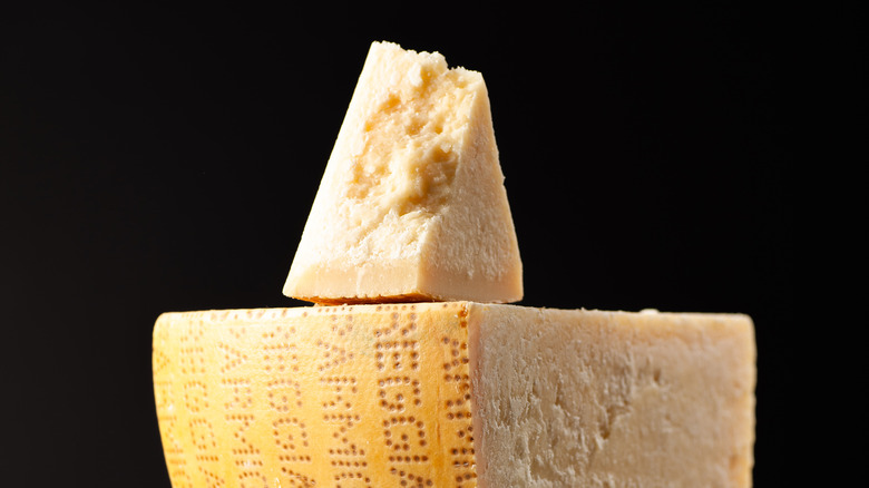 slice of parmesan cheese sitting on top of wheel