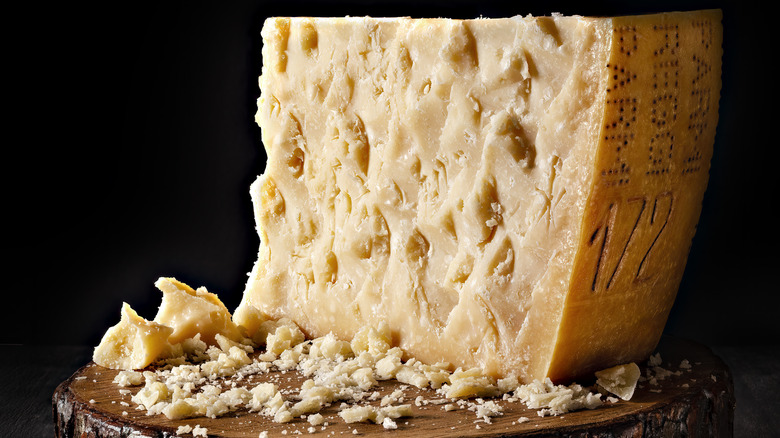 wheel of parmesan cheese with chunks removed