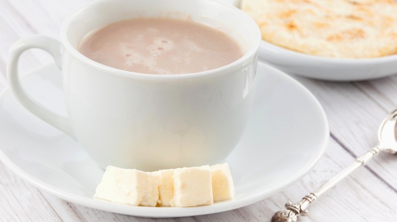 Mug of hot chocolate with cheese cubes
