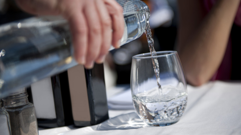 water being poured from a bottle at restaurant