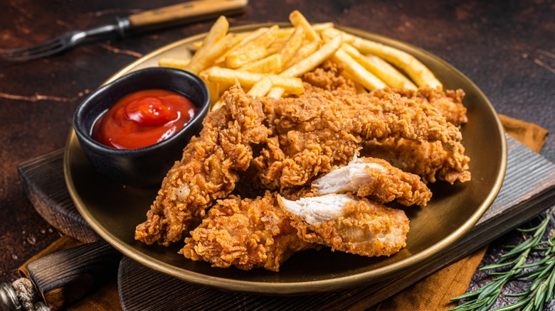 Crispy fried chicken on a black plate