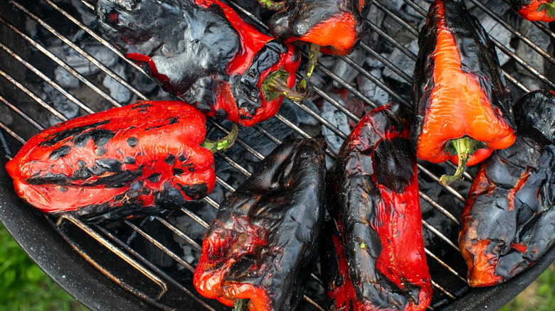 Charred peppers on a grill