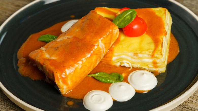 Seafood lasagna garnished with yogurt no black plate