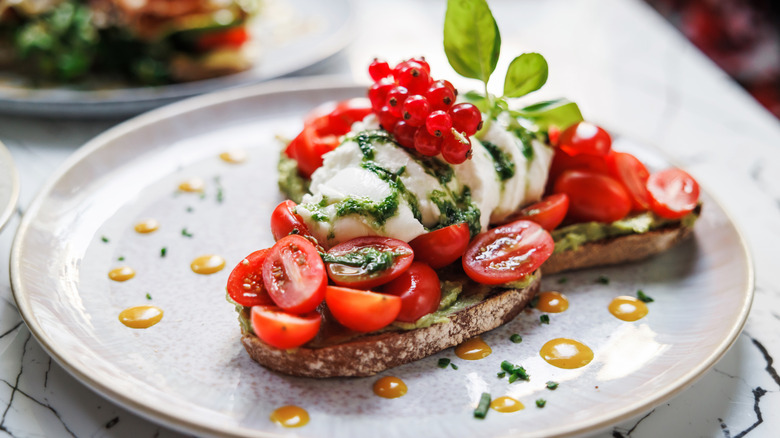 Avocado toast dressed with cherry tomatoes.