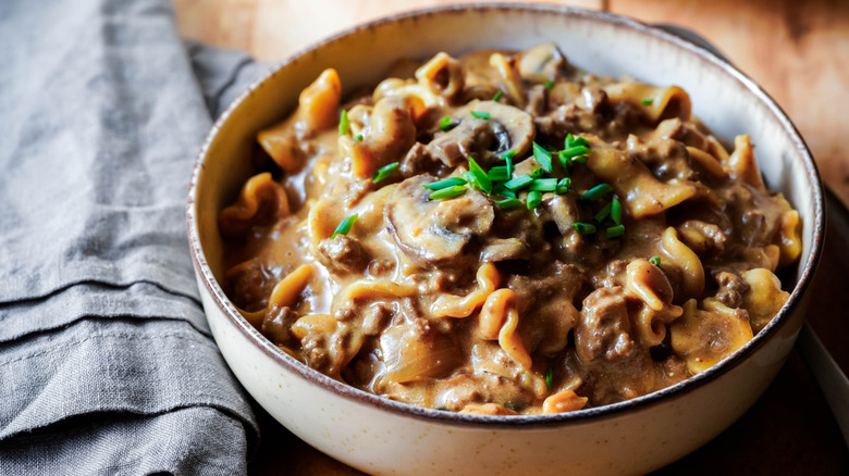 bowl of beef stroganoff topped with chives
