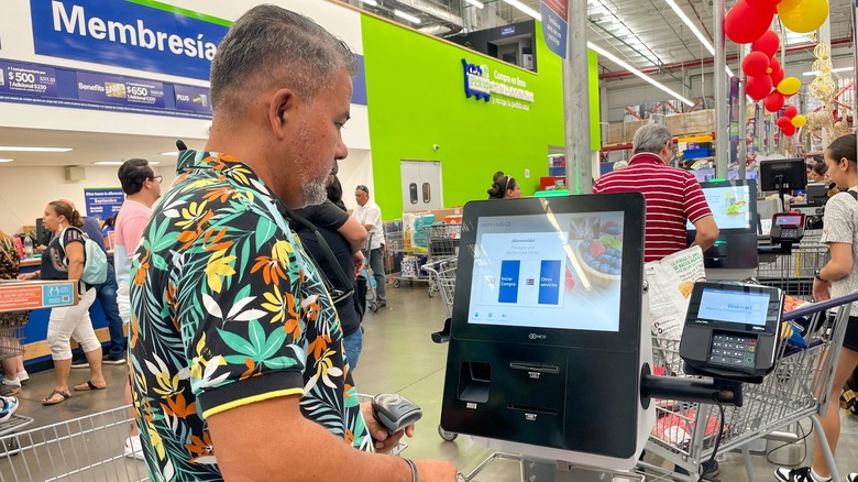 A man uses the Costco self-checkout