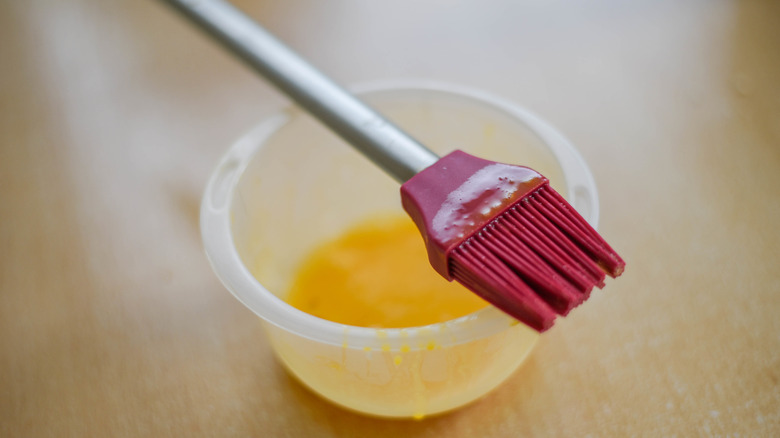 A pastry brush with melted butter
