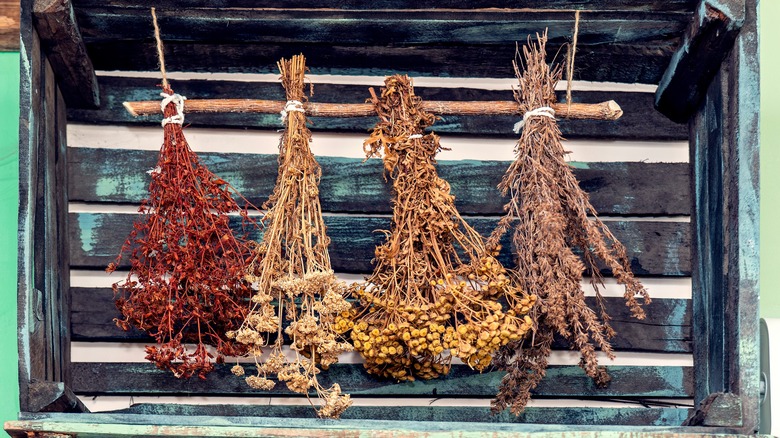 Simple herb drying rack in wooden box.