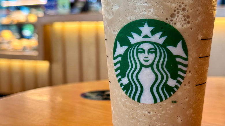 close up of starbucks caramel drink in signature cup