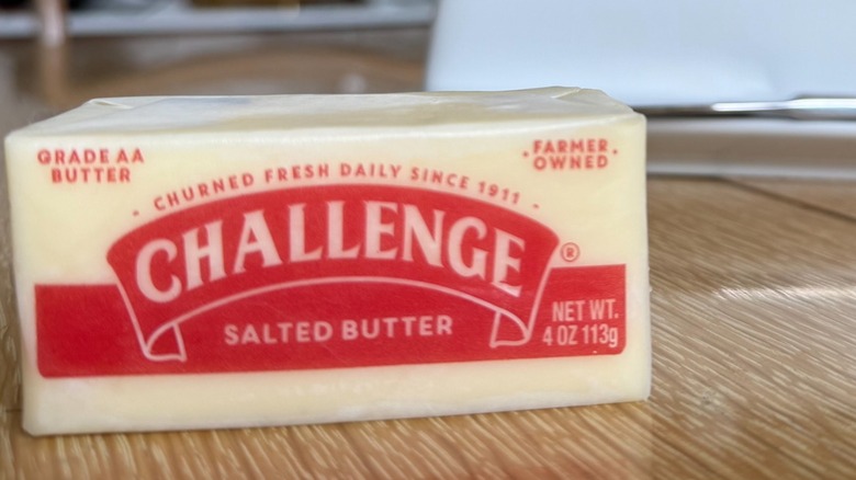 Stick of Challenge Butter from California on wooden table