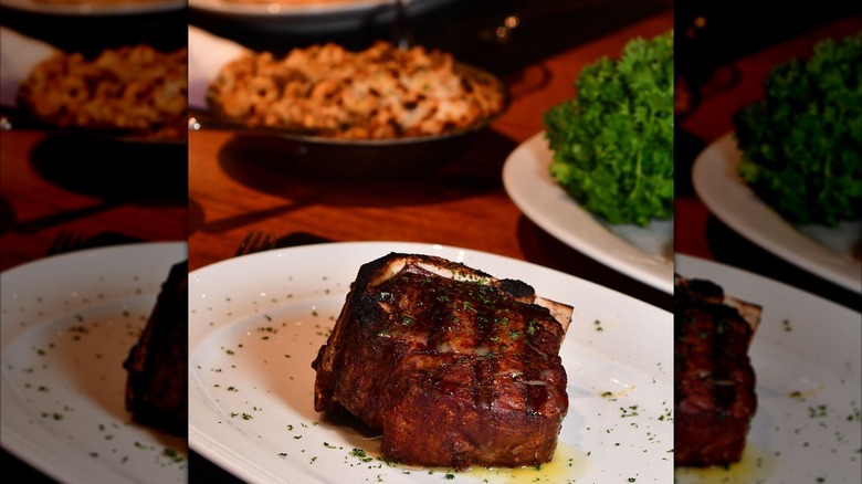 juicy bone-in filet on white plate with herbs