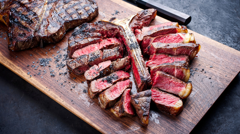 porterhouse steak sliced on cutting board
