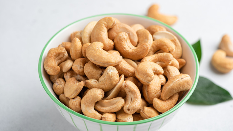 A close-up of a small bowl of roasted cashews