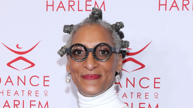 Carla Hall smiling on red carpet.