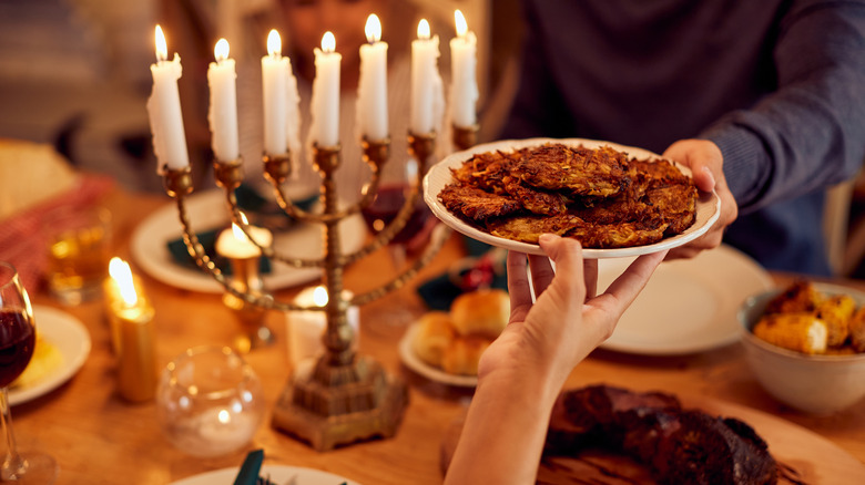 Plate of latkes being passed