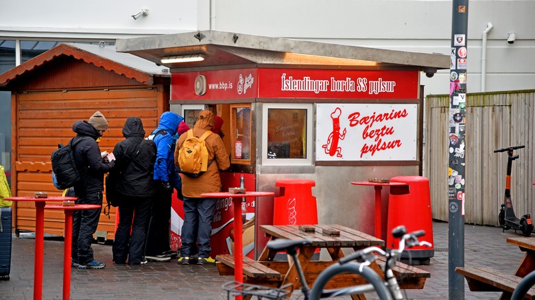 Guests line up outside a pylsur stand in Iceland
