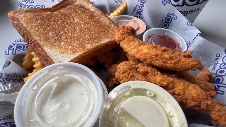 foosackly's basket with toast, dipping sauce, fries, chicken fingers