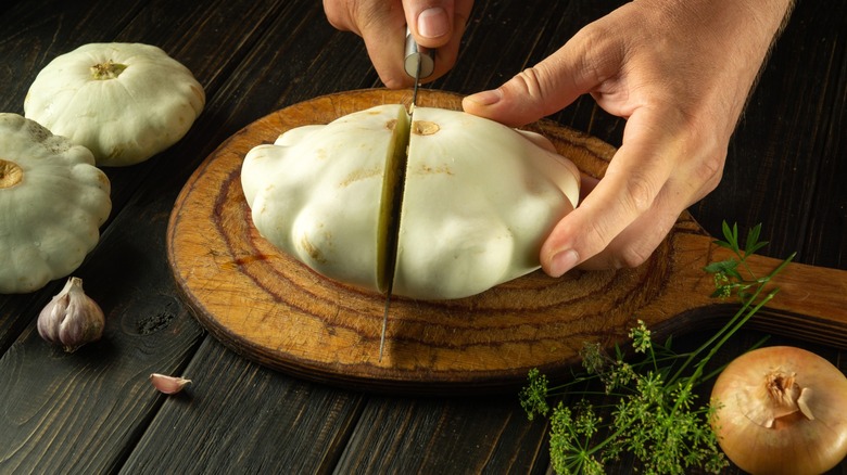hands cut into a tender patty pan squash