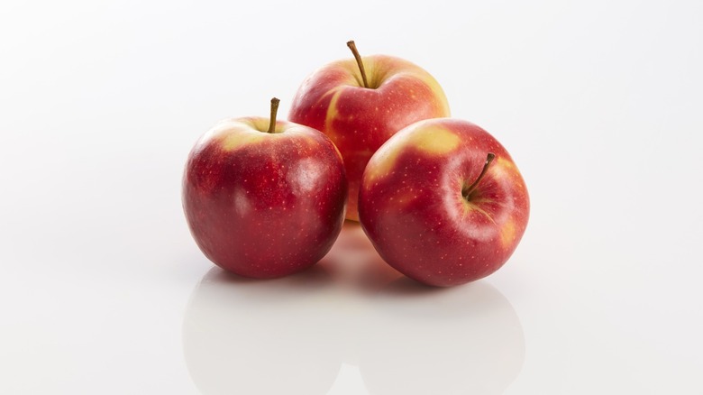 three apples with white background