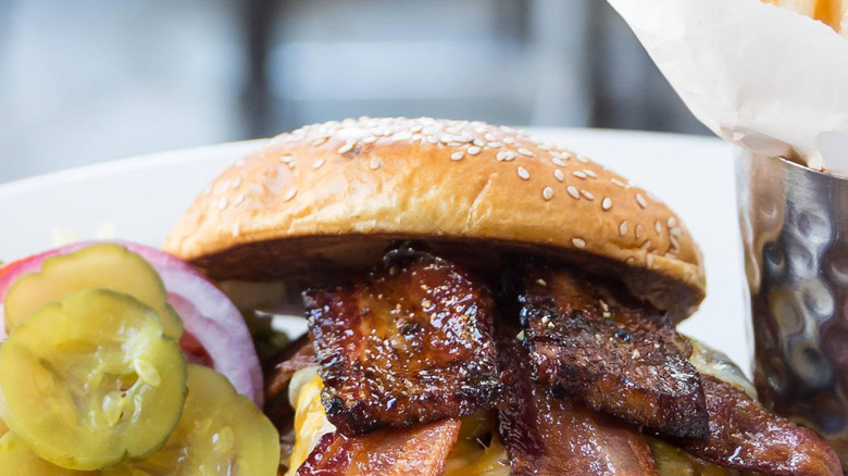Close up of burger with cheese and two kinds of bacon