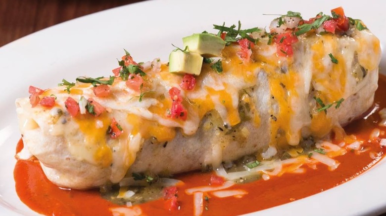 Breakfast burrito in pool of sauce