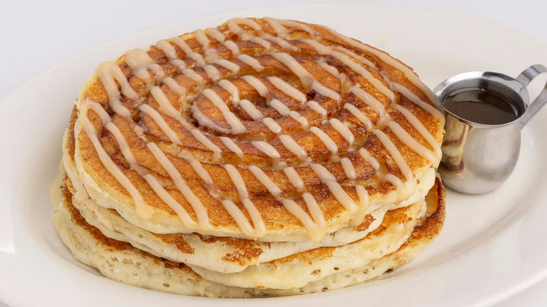 Stack on cinnamon roll pancakes on plate