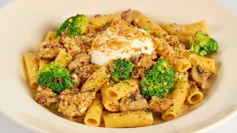 Pile of pasta with mushrooms, broccoli, sausage, and ricotta cheese