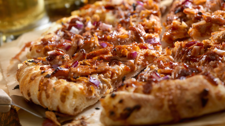 Close up BBQ pulled pork and red onions on pizza