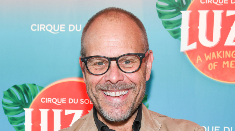 Alton Brown smiles on red carpet
