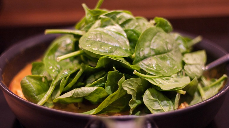 Wilting spinach in pan close up