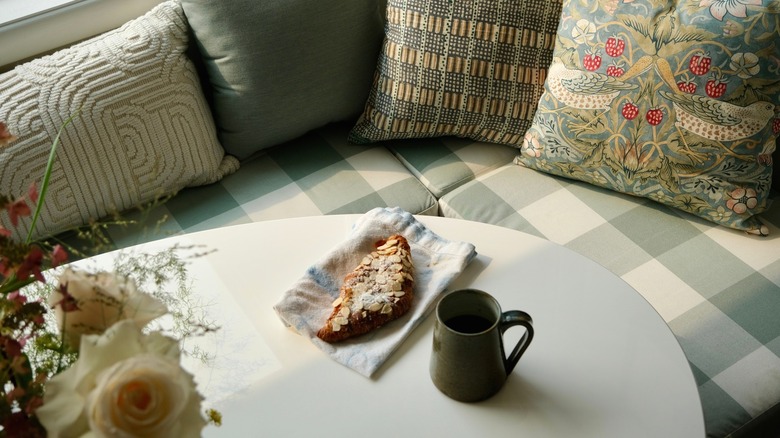 Breakfast nook with coffee and pastry on table