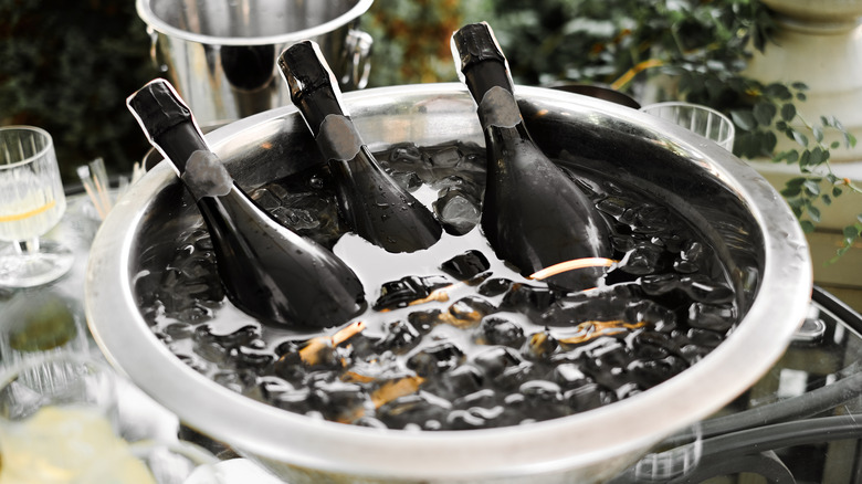 Wine bottles in a ice water bucket