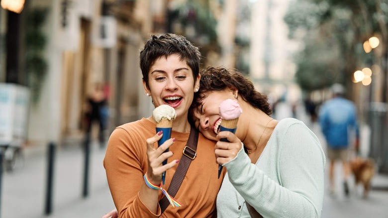 couple walks street and eats ice cream