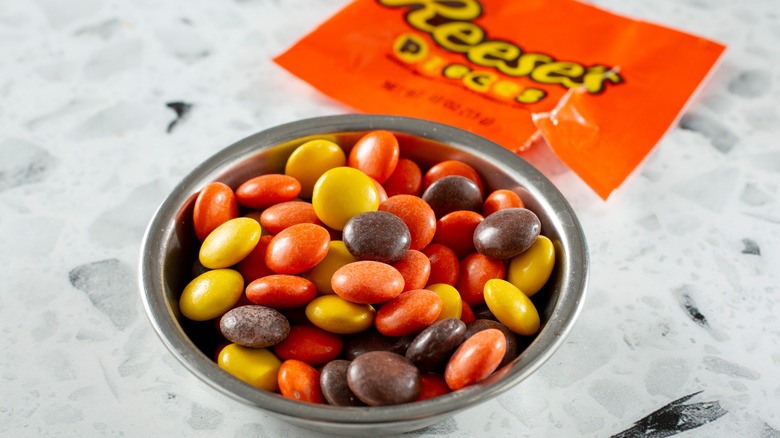 Bowl of Reese's pieces candies.
