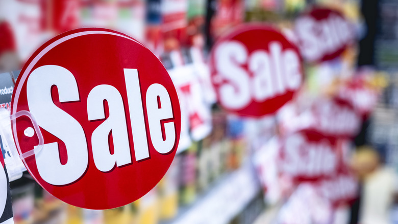 Supermarket aisle shelf with red "sale" tags. 