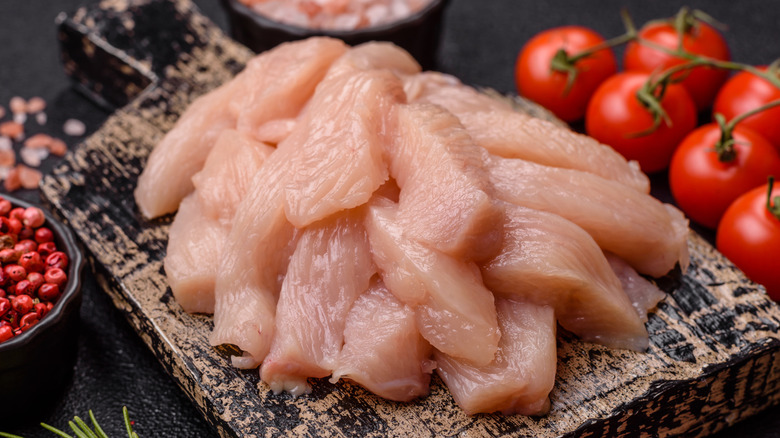 Raw chicken or turkey fillet cut into slices